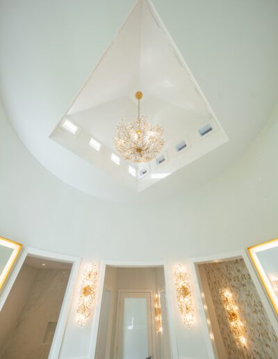 Interior bathroom ceiling with a fancy chandelier