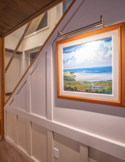 Beach painting on the side of a staircase.